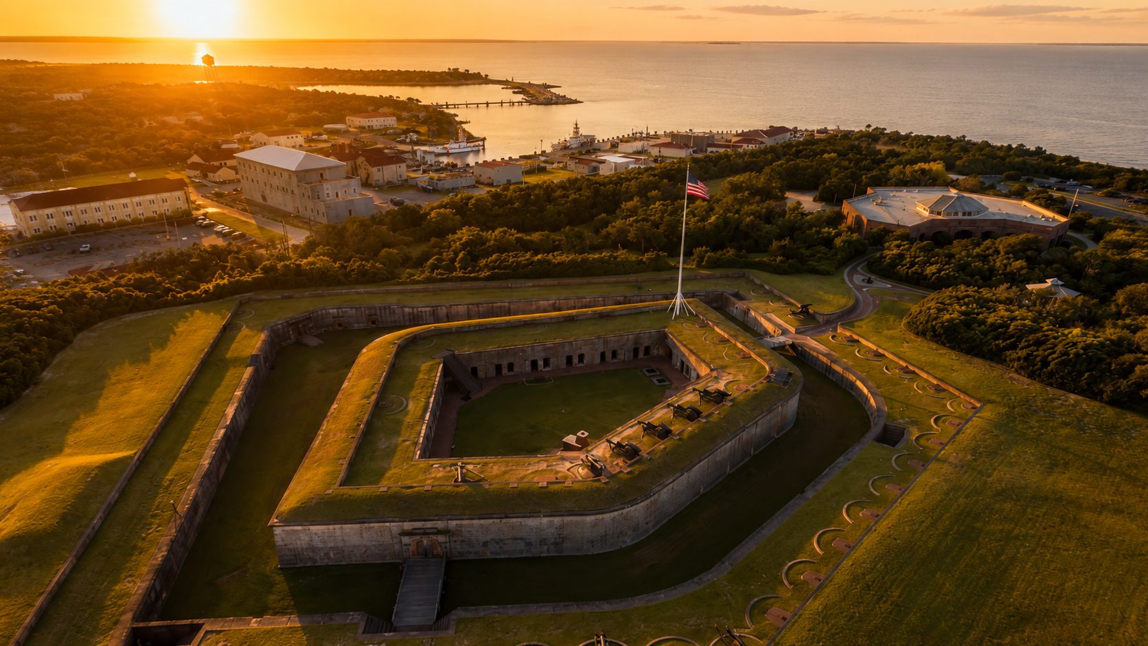 Aerial view of Fort Macon at sunset, with Beaufort Inlet and the Coast Guard station beyond