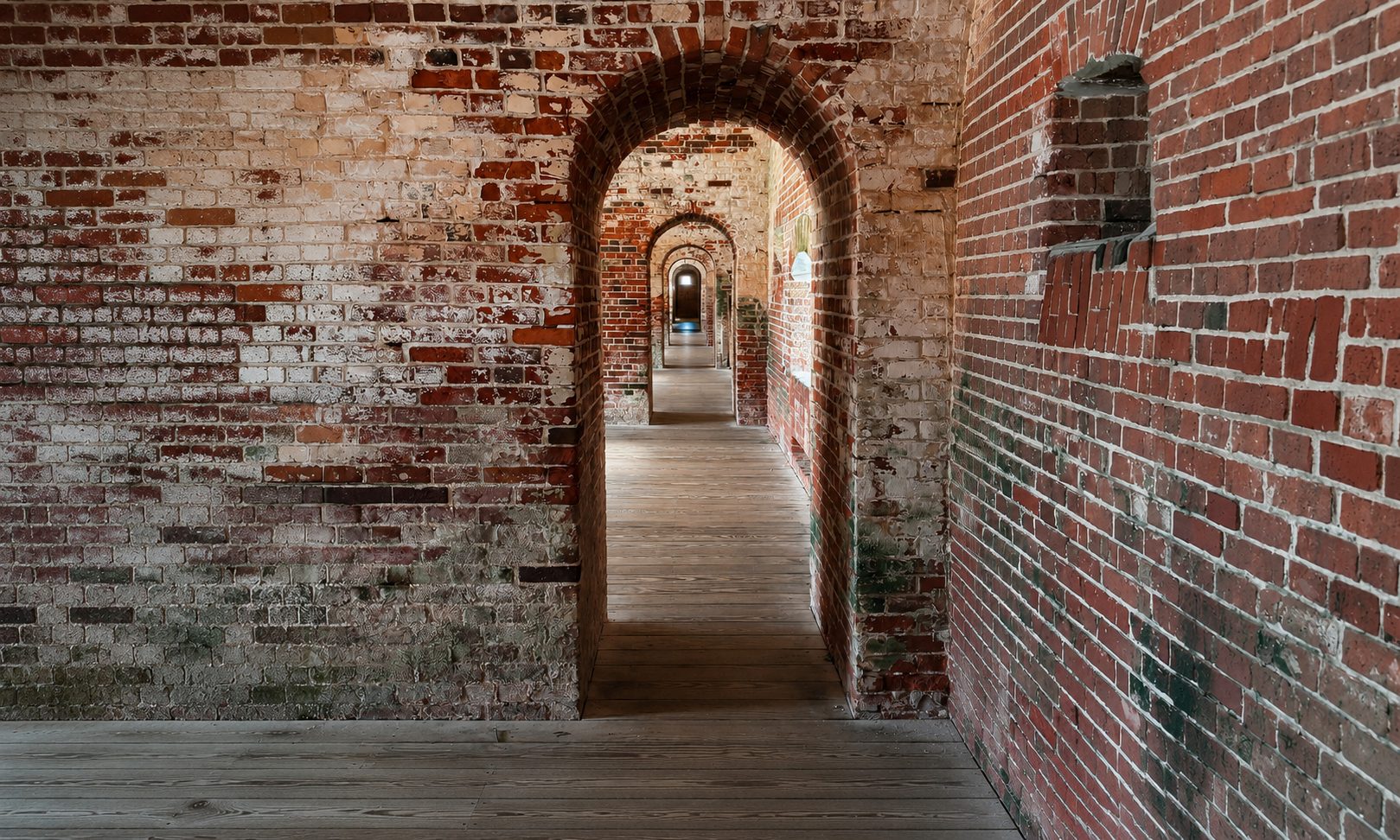 A row of brick archways through the fort's casemates