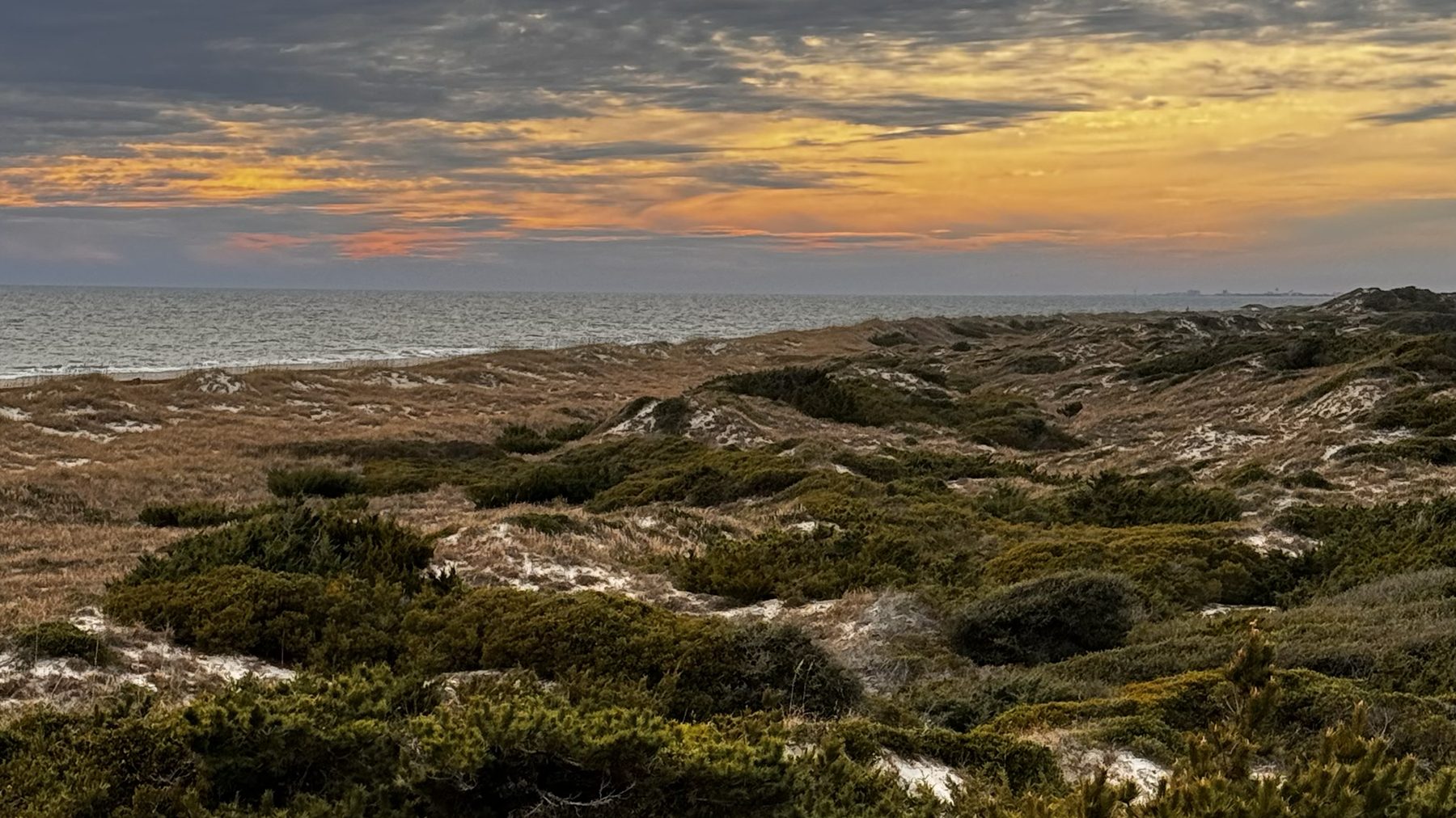 Dunes and sea oats along the Fort Macon shoreline at sunset