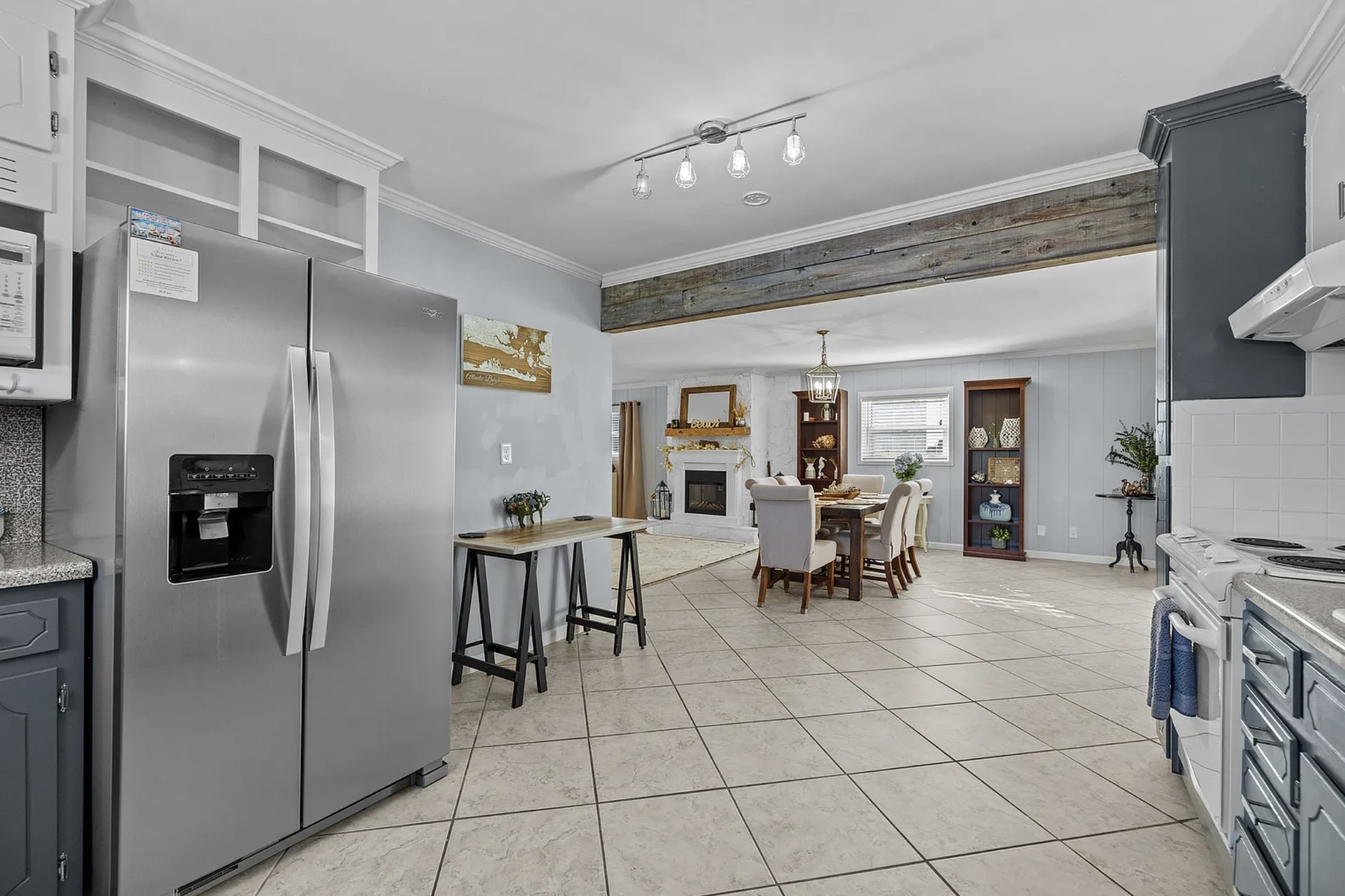 Refrigerator and open shelving with a view through to the dining and living room