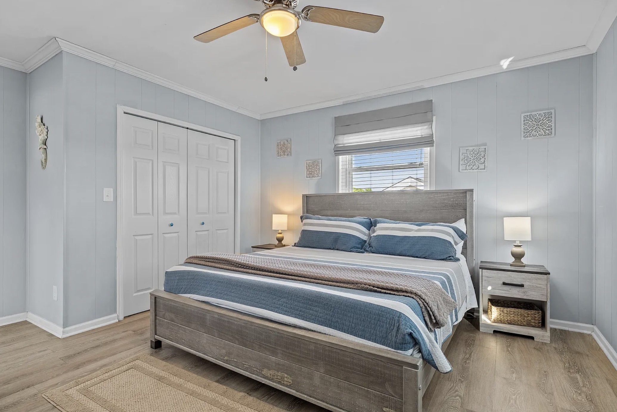 Second king bedroom with gray headboard and striped bedding