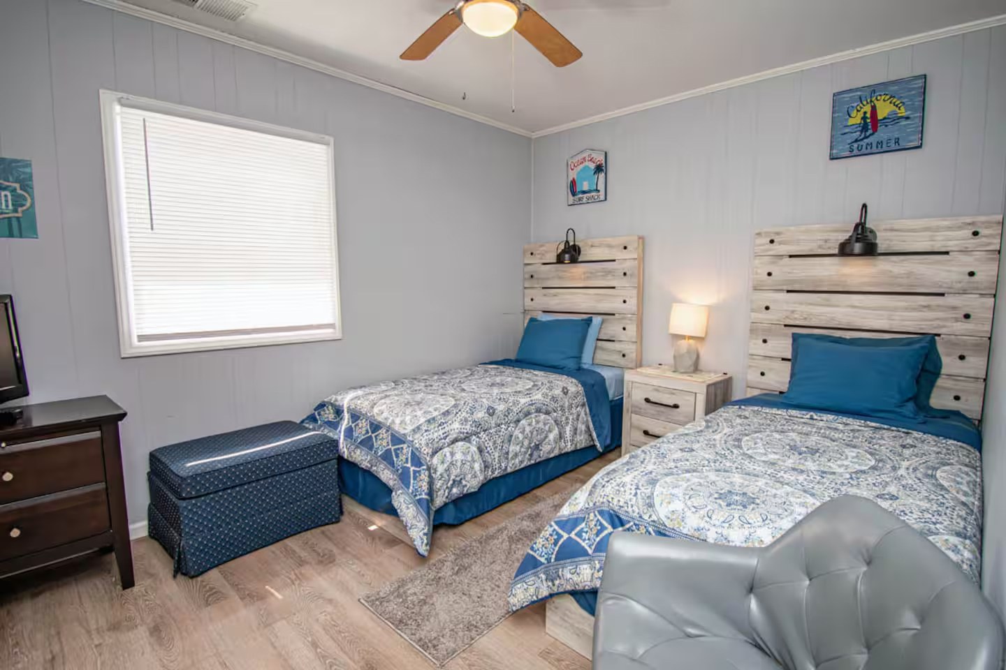 Twin bedroom with matching beds and coastal wall art