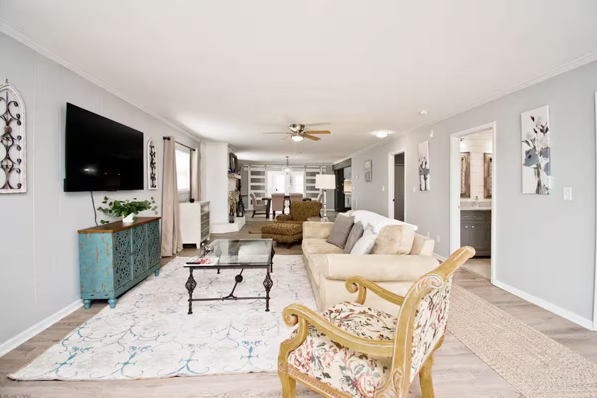 Living room with school-of-fish wall art and barn door TV cabinet