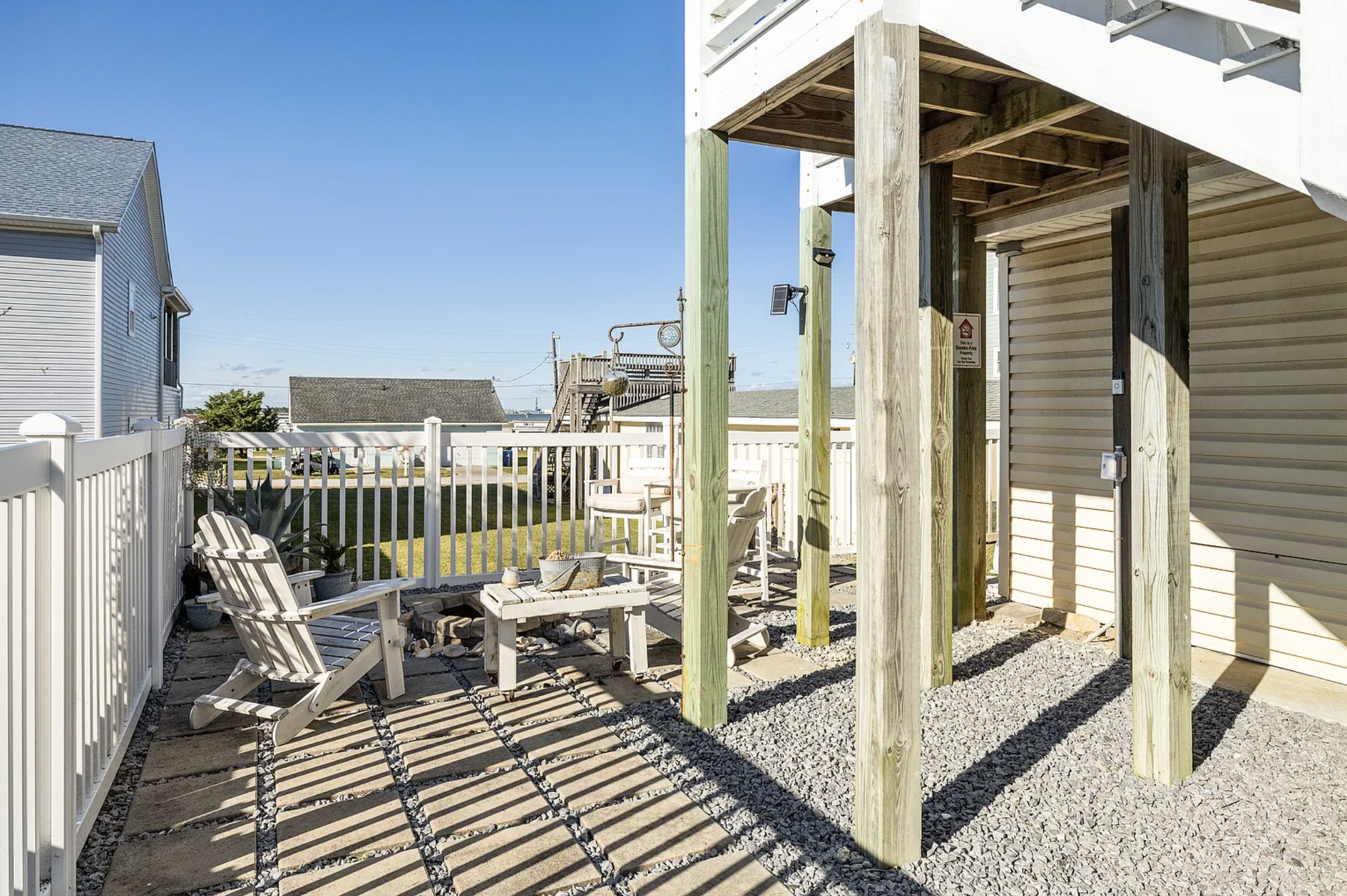 Patio corner with Adirondack chair, agave plants, and rooftop deck view
